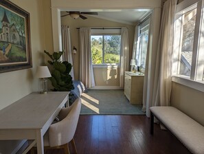 Enjoy a peaceful retreat with a garden view, a comfortable desk, and a relaxing atmosphere.