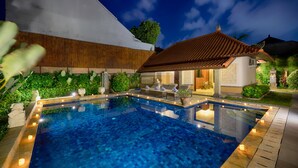 A rectangular swimming pool with tiled edges and a wooden deck surrounding it. - villa deh simba at seminyak oberoi  (Seminyak)
