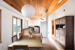 Enjoy cooking in this well-equipped kitchen with a central island, dining area, and large window.