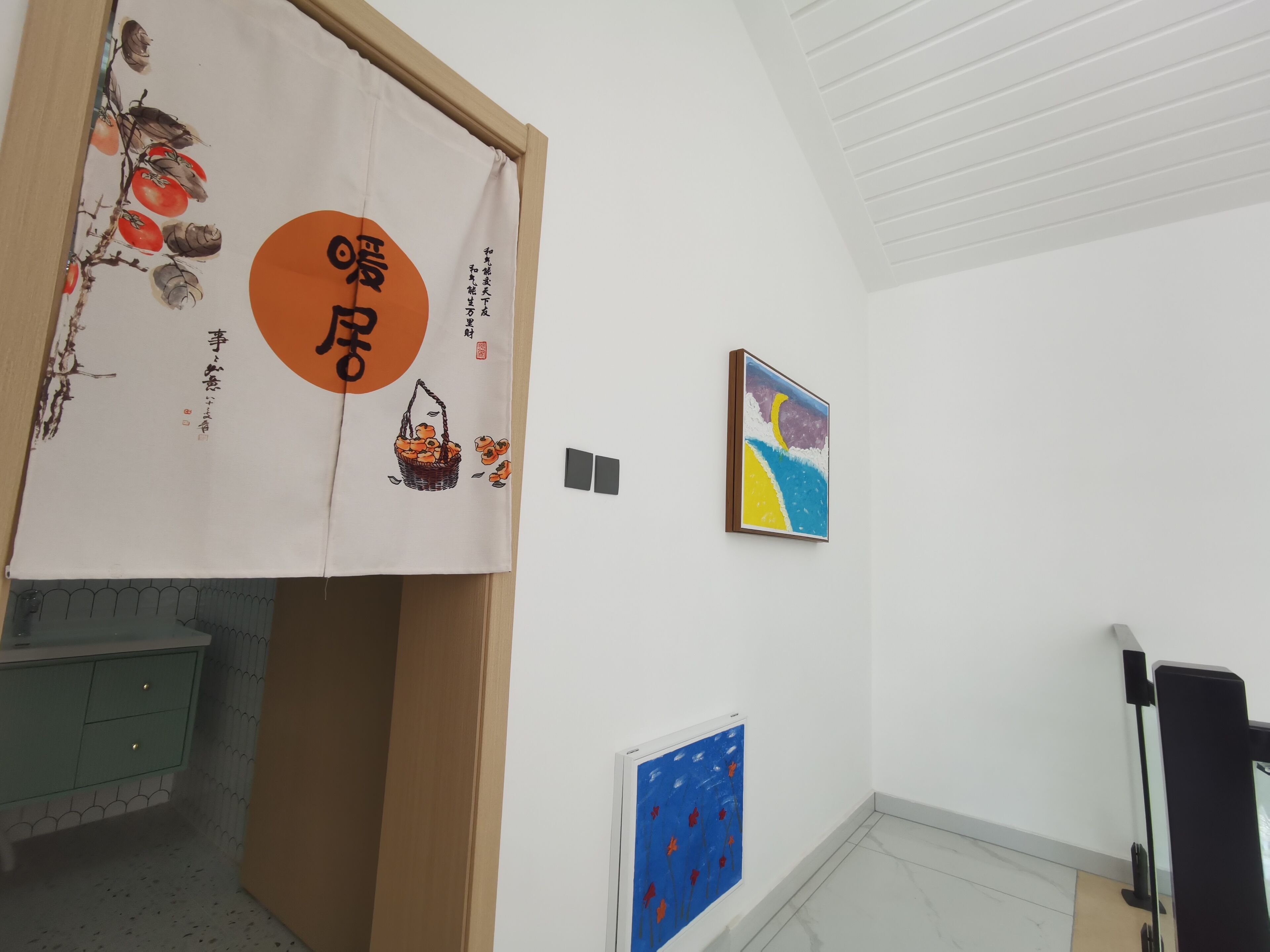 A room with a traditional Japanese sliding door, a framed painting, and a blue patterned wall panel.
