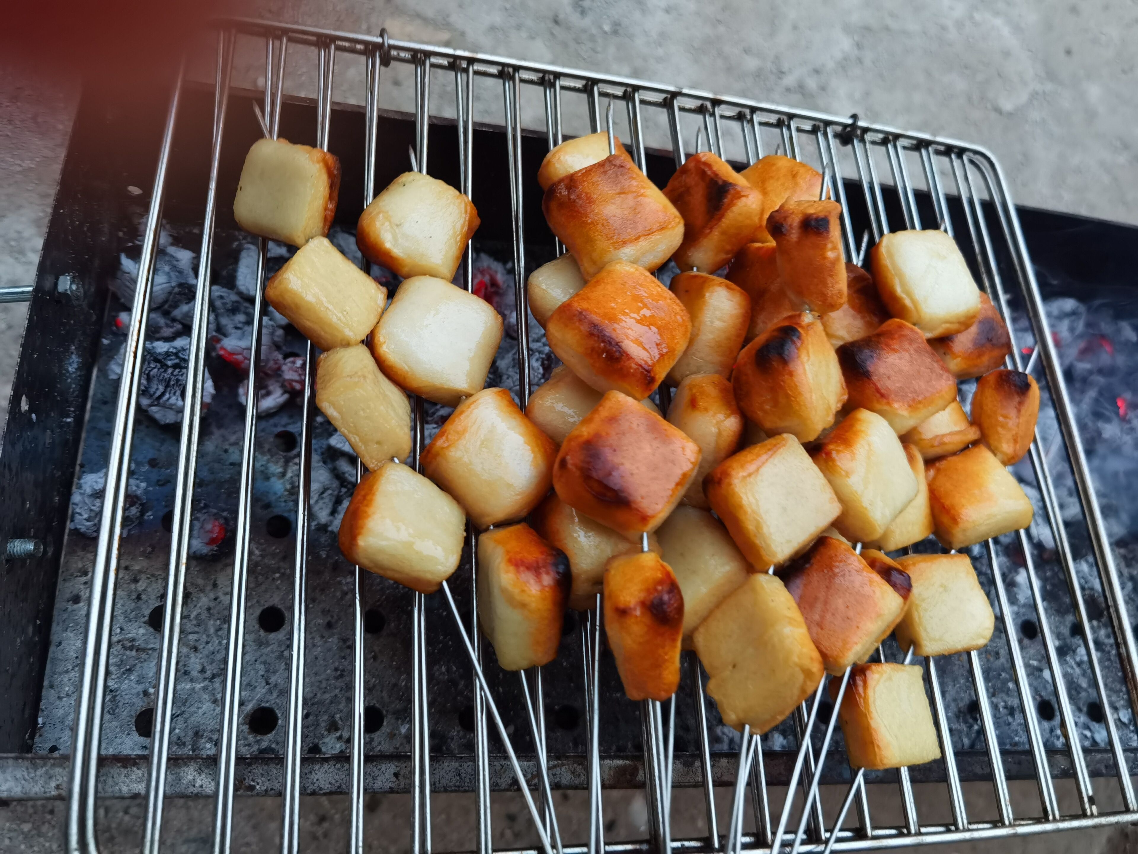 A grill with food items being cooked.