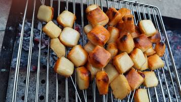 A grill with food items being cooked.