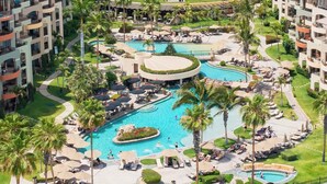 A resort with multiple swimming pools, palm trees, and sun loungers. - Villa La Estancia Resort - Cabo San Lucas-2 bedroom Suite (Cabo San Lucas)