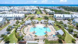 A resort with a central pool, multiple buildings, and a view of the ocean. - Watersound Escape by Stay on 30a (Inlet Beach)
