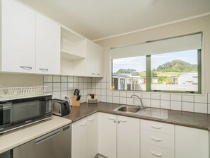 Fridge, microwave, dishwasher, toaster - Sandy Feet Retreat - Cooks Beach Holiday Home (Cooks Beach)
