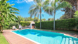 A rectangular swimming pool with a wooden deck surrounding it. - Modern villa in Las Rotas with air conditioning (Denia)