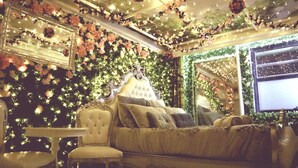A luxurious bedroom with a large bed, ornate headboard, and a chandelier. - Secret Garden - A Magical Themed Studio in the heart of Melbourne CBD (Melbourne,)