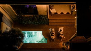 An aerial view of a rooftop pool area with a large pool, two lounge chairs, and a staircase leading to an upper level. - Hot Tub/Pool, Views, Pets-Catalina Foothills Casa (Tucson)