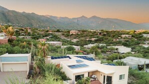 A residential area with houses, some with solar panels, surrounded by greenery and mountains. - Hot Tub/Pool, Views, Pets-Catalina Foothills Casa (Tucson)