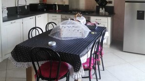 A kitchen with white cabinets, a chandelier, and a dining table with chairs. - Gorgeous shabby rustic on Tuscan hills, pool on request (Capannori)