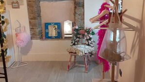 A room with a stone fireplace, a small table with a floral arrangement, and a hanging lamp. - Gorgeous shabby rustic on Tuscan hills, pool on request (Capannori)