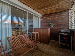 Relax in a warm and inviting space with a comfortable bench and sliding glass door leading to an outdoor area.