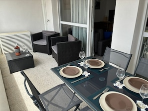 A dining area with a table set for four, including plates, cutlery, and glasses.
