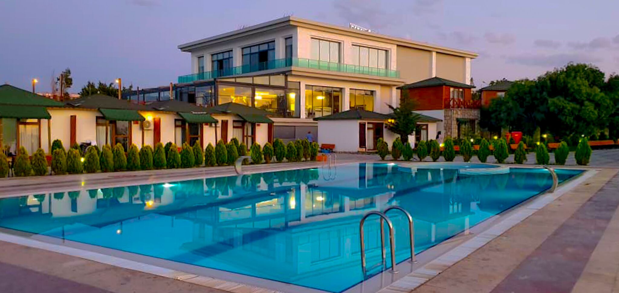 A swimming pool with a modern building in the background.