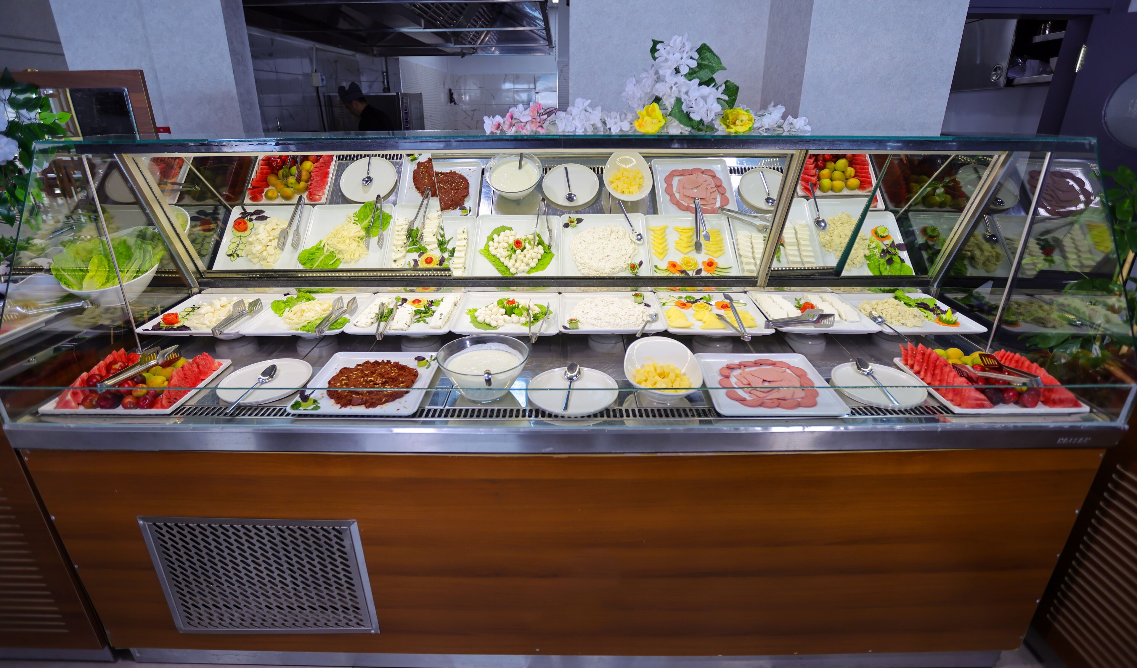 A buffet with various food items and utensils.