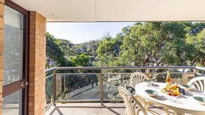 Enjoy a romantic meal for two on this balcony overlooking a serene landscape.