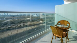 A balcony with a clear view of a cityscape and highway.