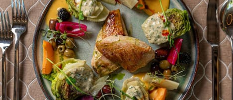A plate of food with various vegetables and a piece of meat.