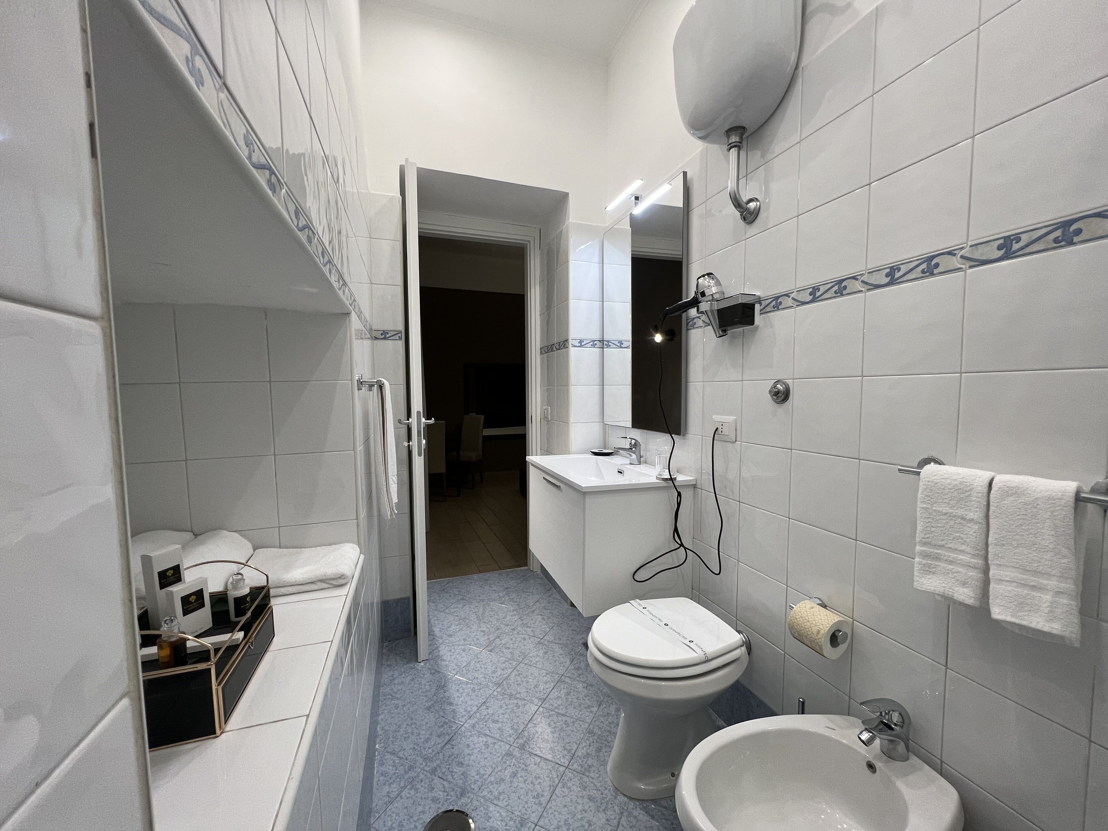 A modern bathroom with a toilet, bidet, and sink.