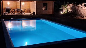 A swimming pool with a wooden deck area, a barbecue grill, and outdoor seating. - Spacious Holiday Home in Doische With Private Pool (Doische)