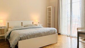 A bedroom with a bed, nightstands, a desk, and a wardrobe. - Chic & Spacious Getaway in Nice - 10 min to Beach (Nice)