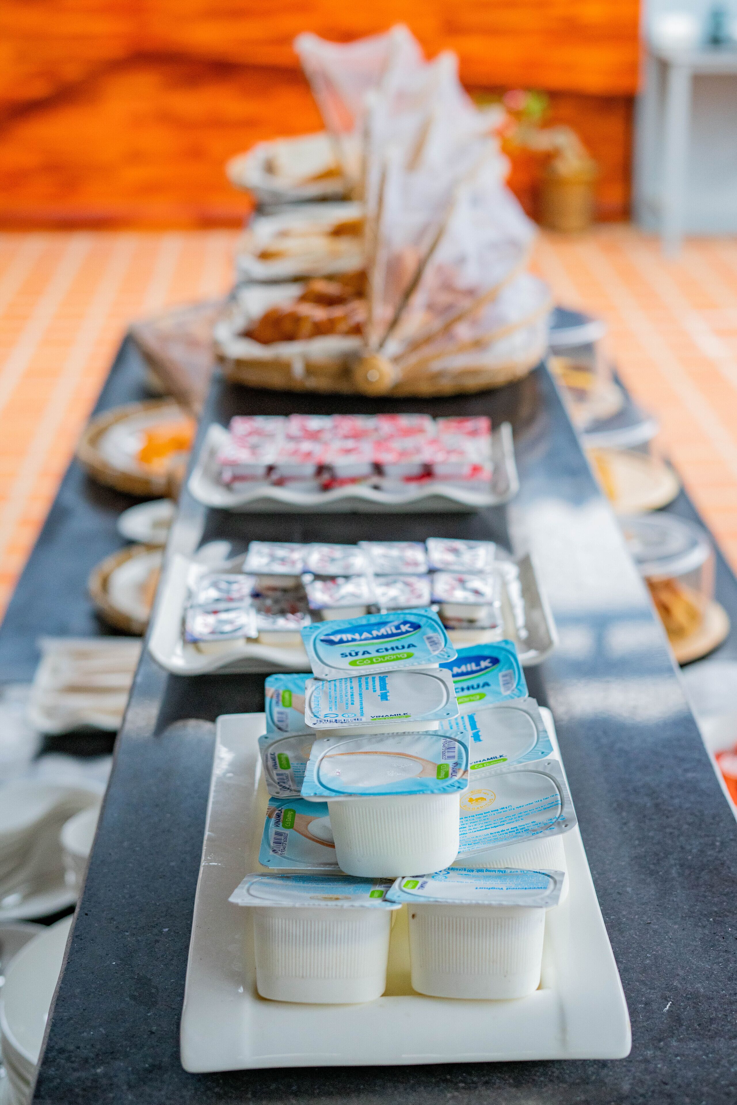 A buffet table with various food items and dairy products.