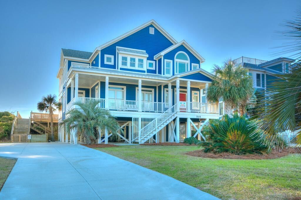 A two-story house with a balcony, a staircase, and a front porch.