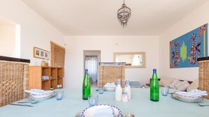 A dining area with a table set for two, featuring plates, cutlery, and glasses. - 3315 Villetta Carmela by Barbarhouse (Alliste)