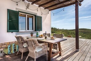 Enjoy al fresco dining on the deck, surrounded by lush views and a charming pergola.