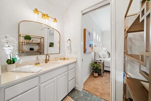 Bathtub, hair dryer, towels, shampoo