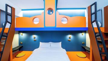 A bunk bed room with orange and blue walls, a ladder on each side, and a central circular window.