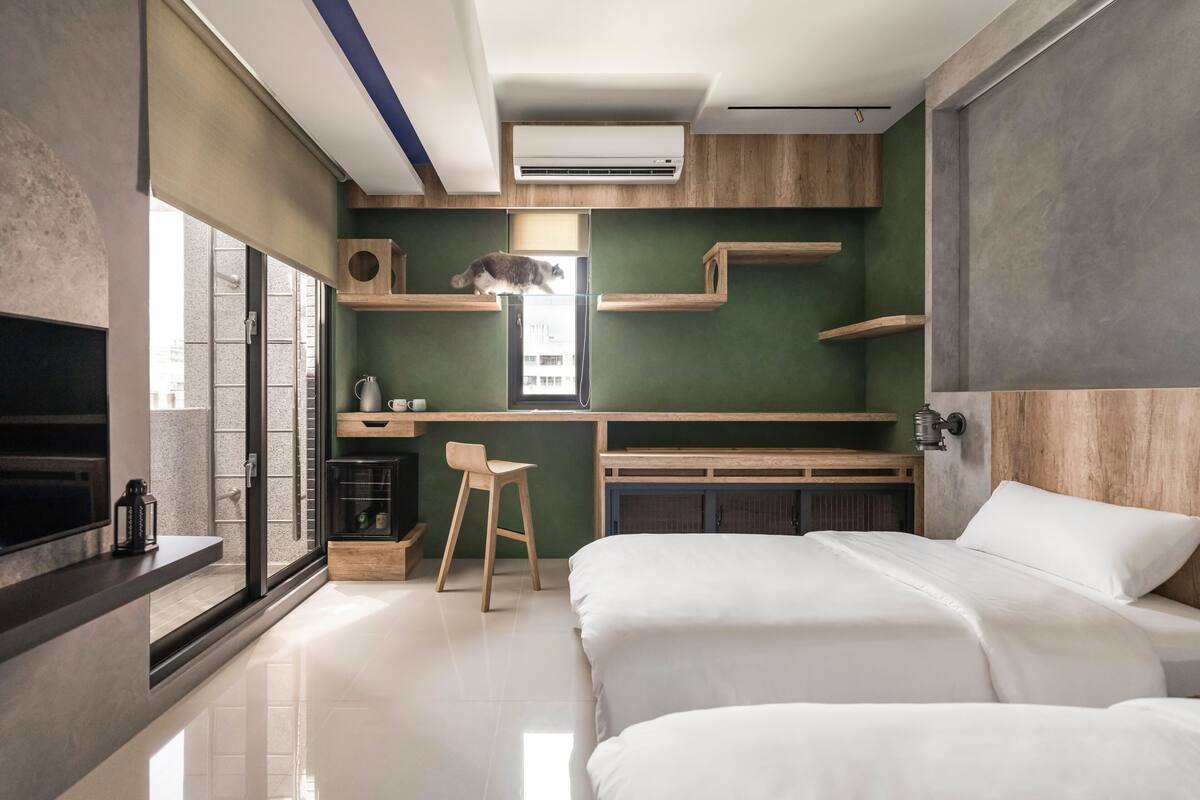 A modern bedroom with a bed, a desk, and a chair.