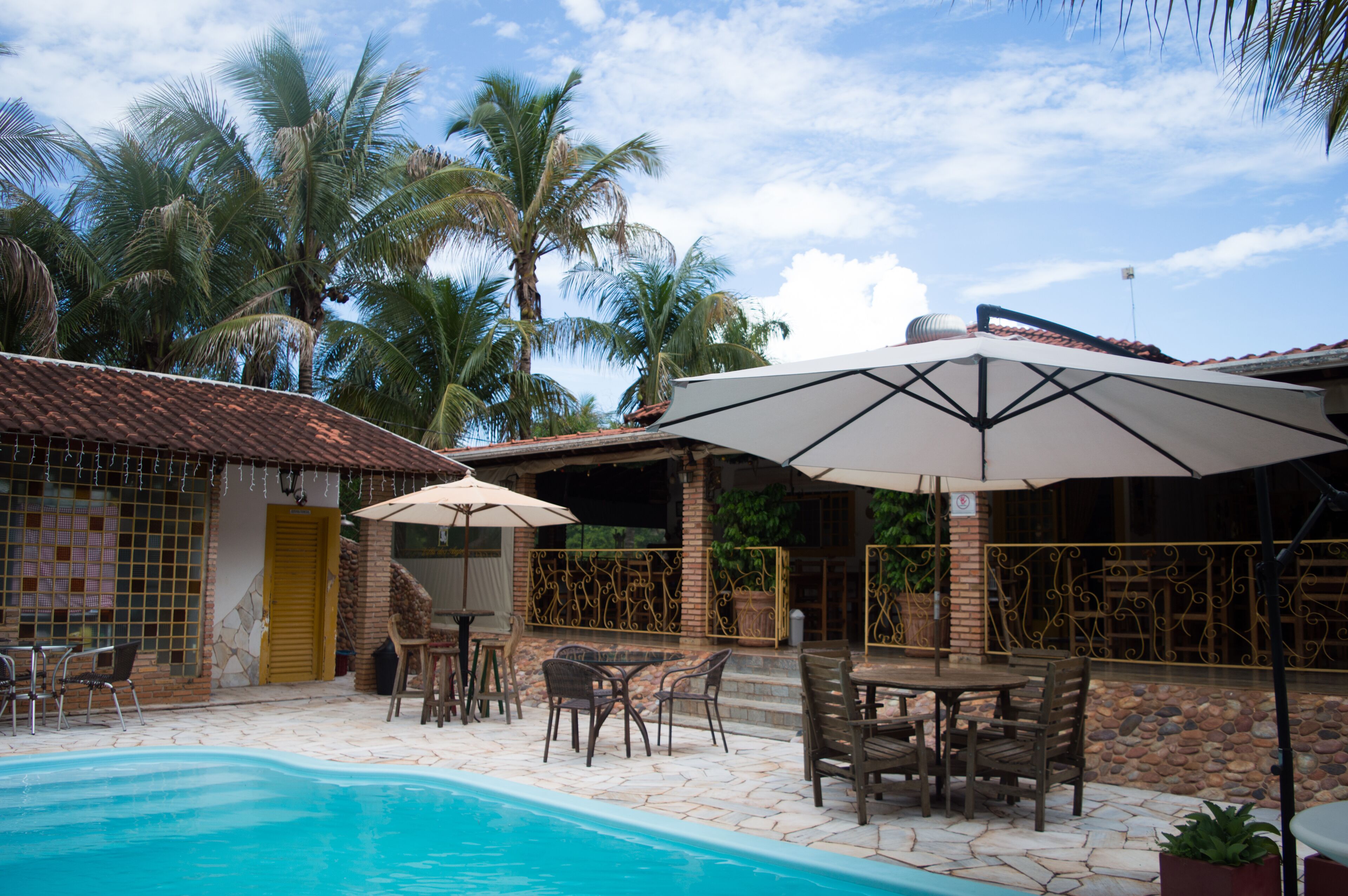 Outdoor pool, open 10:00 AM to 8:00 PM, pool umbrellas