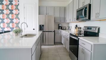 Townhome | Private kitchen | High chair, dining tables