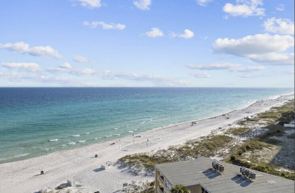 A beach view with a building in the foreground.