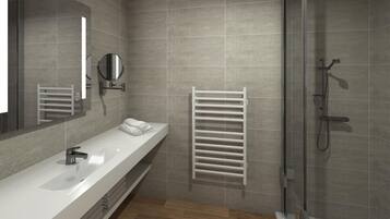A modern bathroom with a large mirror, a white sink, a towel rack, and a shower area.