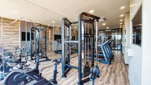 A modern gym with various exercise equipment, including treadmills and weight machines, arranged in a spacious layout. - Spectacular + cozy brand new apartment! (Santa Cruz de la Sierra)