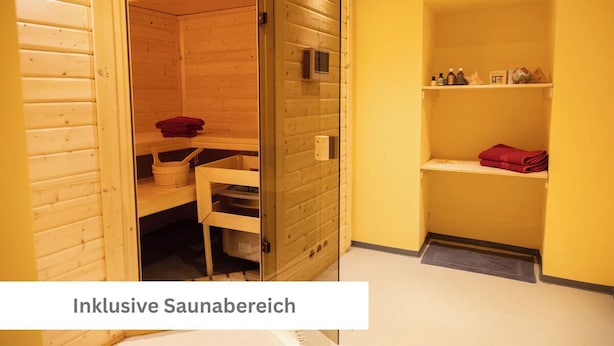 A sauna room with wooden walls, a glass door, and a shelf with towels and bottles.