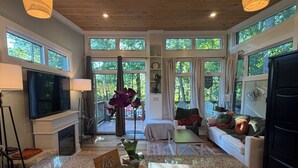 A spacious kitchen with granite countertops, a central island, and pendant lighting. - The Monarch: A Pinehurst Retreat (Carthage)