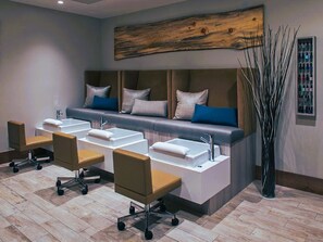 Relax in a serene space with a long bench and two sinks, surrounded by natural decor and flexible seating.
