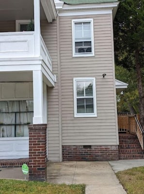 Two-story home with a brick column and a garage door.