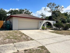 Attached to the house, this garage offers a convenient space for parking and storage.