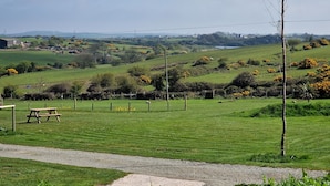 A rural landscape with a picnic table and a path. - Swift Vogue Edition Caravan (Holyhead)