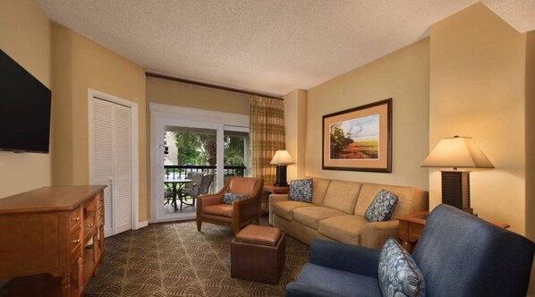 Relax in a comfortable seating area with a sofa and armchairs, perfect for unwinding.