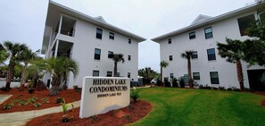 A modern building with a sign reading "Hidden Lake Condominiums." - On 30A, walk to 2 beaches, 1 King bed/attached bathroom, pool, gym (Santa Rosa Beach)