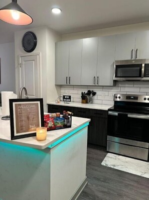 Enjoy cooking in this well-equipped kitchen with a central island, oven, and microwave.