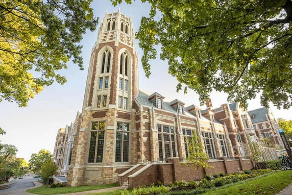A historic building with a prominent tower and large windows.