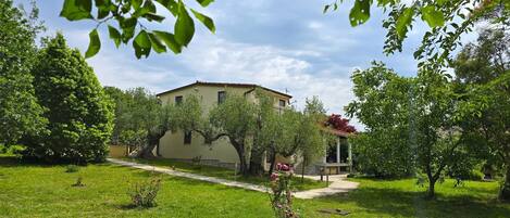 A two-story building with a garden in front.