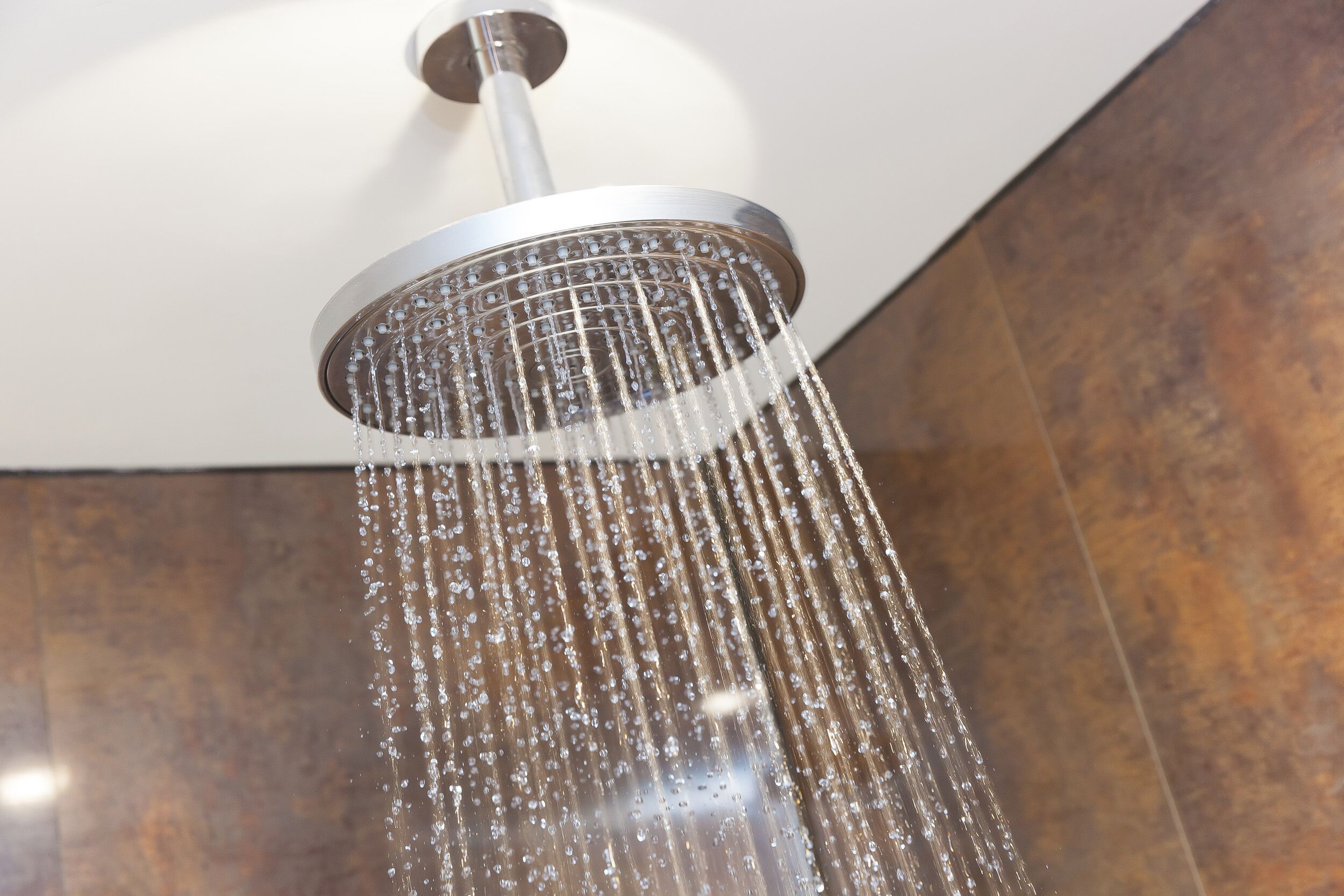 A showerhead with water flowing from it.