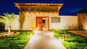 A stone building with a wooden door and a sign that reads "Villa La Gorda." - VILAGOA POUSADA (Coqueiro Seco)